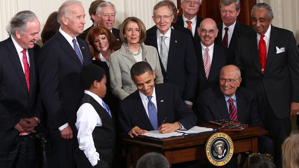 President Barack Obama signs the Affordable Health Care for America Act in the East Room of the White House on March 23, 2010. 